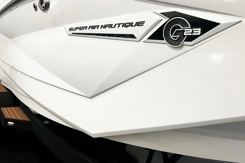 Slide: The Image of 2022 Nautique Super Air Nautique G23 boat, sleek white design with logo detail. - 7