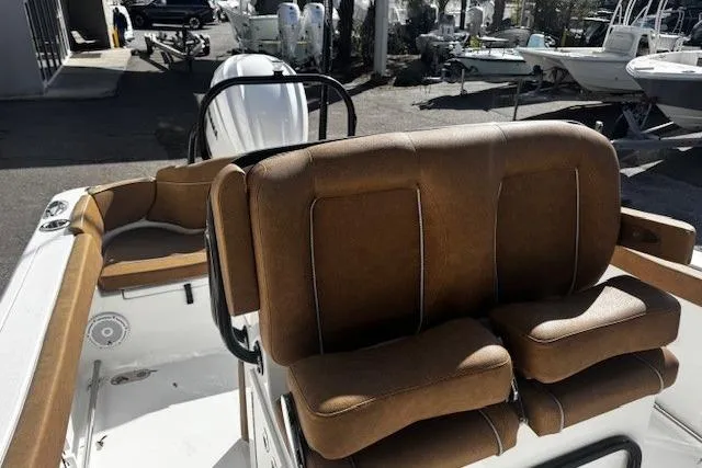Slide: The Image of 2023 Sea Hunt Ultra 255 SE boat interior with brown seating and modern design. - 10