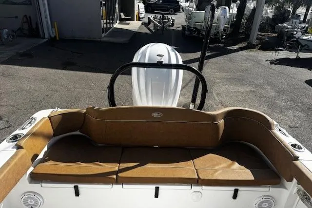 Slide: The Image of 2023 Sea Hunt Ultra 255 SE boat with tan seating and outboard motor. - 12