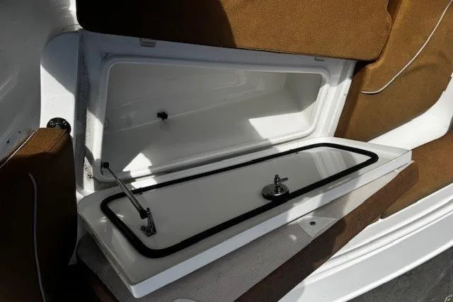 Slide: The Image of 2023 Sea Hunt Ultra 255 SE storage compartment with open lid, showcasing interior space. - 14