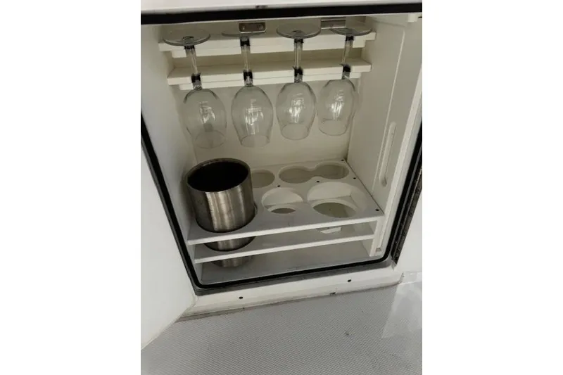 Slide: The Image of 2023 Sea Hunt Ultra 255 SE boat bar with glass holders and ice bucket. - 16