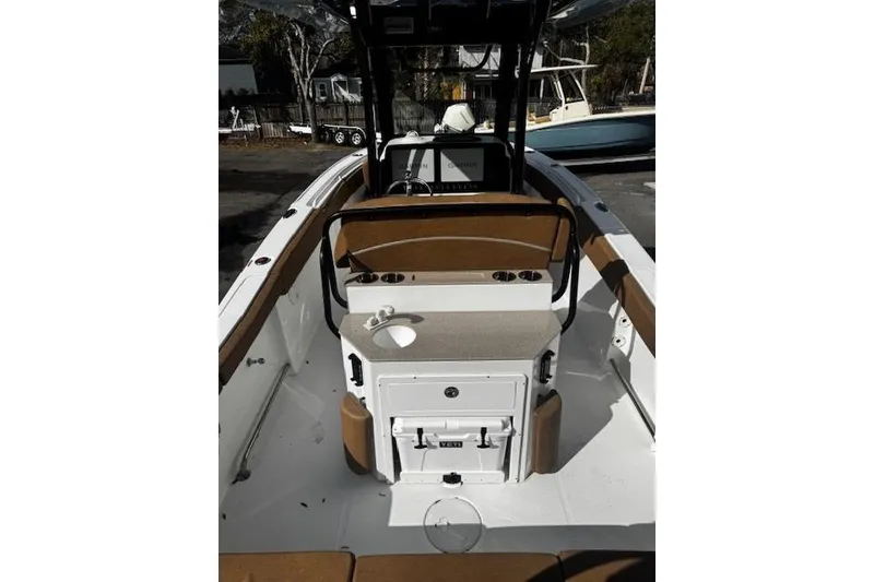 Slide: The Image of 2023 Sea Hunt Ultra 255 SE boat interior with seating and console. - 2