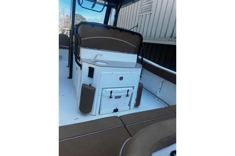 Slide: The Image of 2023 Sea Hunt Ultra 255 SE boat interior with seating and storage. - 3