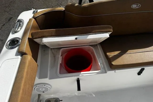Slide: The Image of 2023 Sea Hunt Ultra 255 SE boat interior with storage compartment and seating. - 4