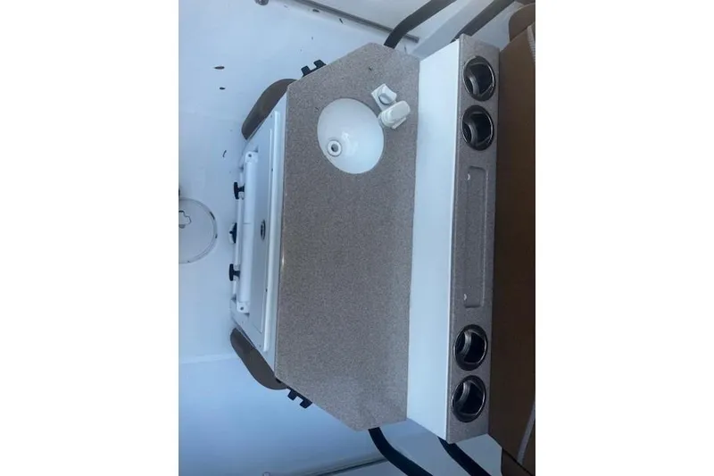 Slide: The Image of 2023 Sea Hunt Ultra 255 SE boat interior with sink and storage compartments. - 7