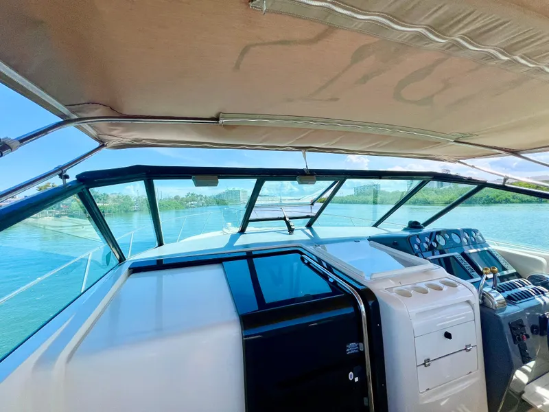 Slide: The Image of 1998 Tiara Yachts 3500 Express cockpit with clear view of water and controls. - 14