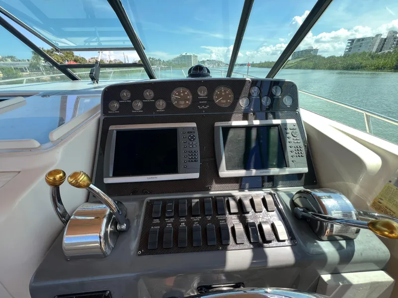 Slide: The Image of Control panel of a 1998 Tiara Yachts 3500 Express with navigation screens and throttle levers. - 15