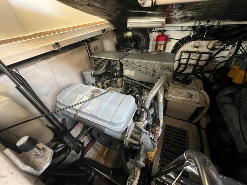 Slide: The Image of Engine compartment of a 1998 Tiara Yachts 3500 Express, showcasing mechanical components and wiring. - 26