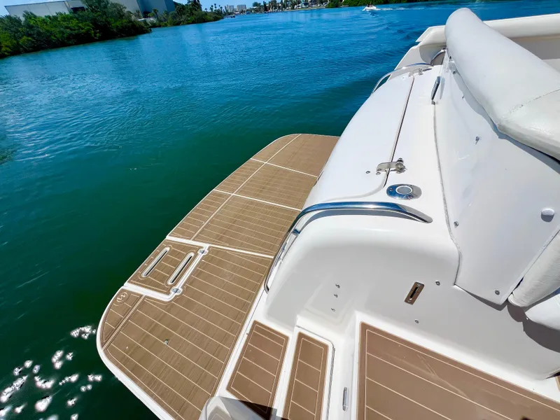 Slide: The Image of 1998 Tiara Yachts 3500 Express boat deck on serene water. - 3
