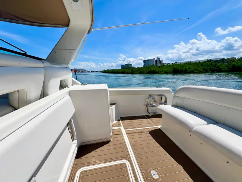 Slide: The Image of 1998 Tiara Yachts 3500 Express interior with scenic water view and clear blue sky. - 6