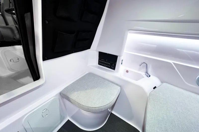 Slide: The Image of Interior of 2025 Axopar 25 Cross Top boat with seating and sink. - 11