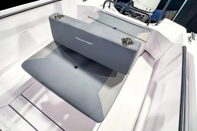 Slide: The Image of 2025 Axopar 25 Cross Top boat interior with gray seating and cup holders. - 16