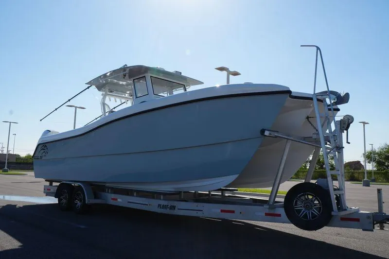 The Image of 2025 Renaissance Prowler 31 boat on trailer in parking lot, side view. - 0