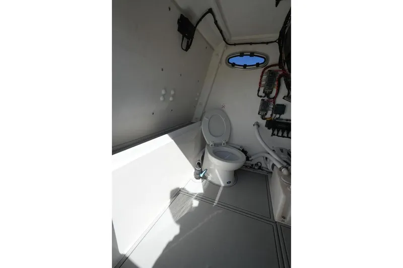 Slide: The Image of Interior of 2025 Renaissance Prowler 31 boat featuring a compact marine toilet. - 10