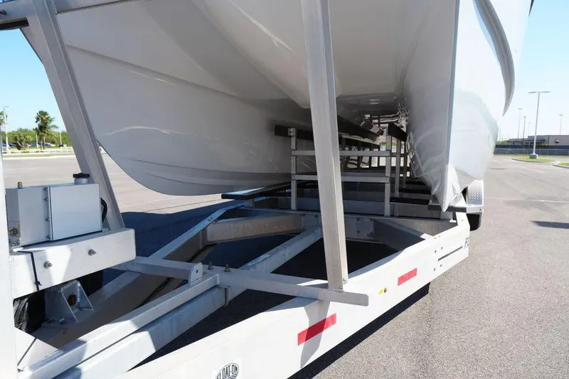 Slide: The Image of 2025 Renaissance Prowler 31 boat on trailer, showcasing sleek hull design. - 11