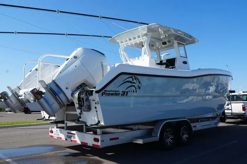Slide: The Image of 2025 Renaissance Prowler 31 boat on trailer, featuring dual outboard motors. - 2