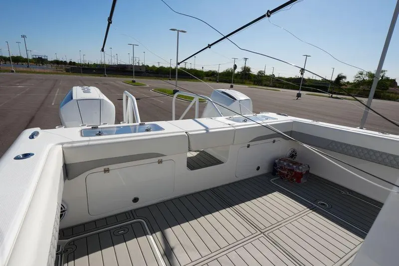 Slide: The Image of 2025 Renaissance Prowler 31 boat interior with dual engines in a parking lot. - 4