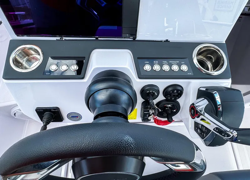 Slide: The Image of Steering console of 2025 Axopar 25 Cross Top boat with controls and cup holders. - 8