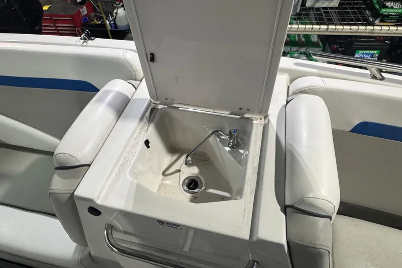 Slide: The Image of 2021 Starcraft SVX 231 OB boat sink with open lid and faucet. - 12