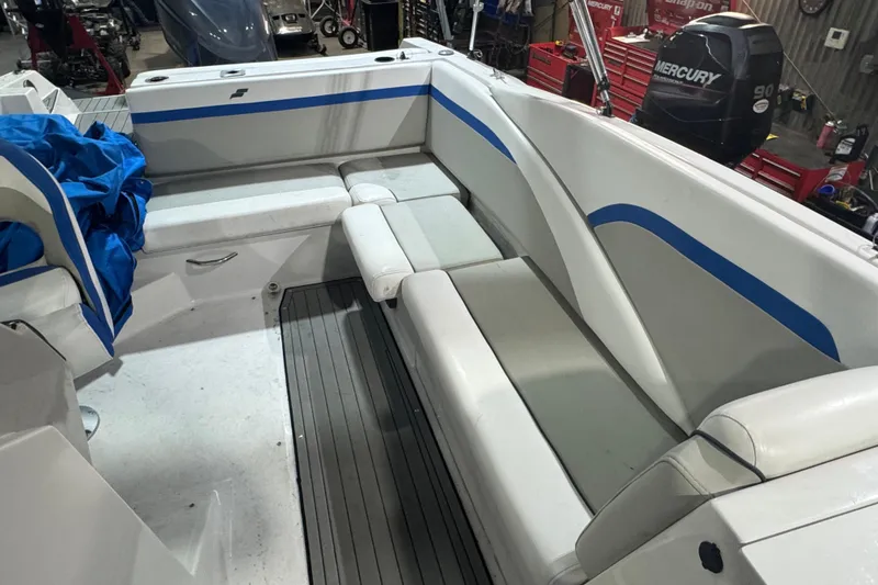 Slide: The Image of 2021 Starcraft SVX 231 OB boat interior with cushioned seating and blue accents. - 14