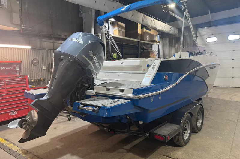 Slide: The Image of 2021 Starcraft SVX 231 OB boat with Yamaha outboard motor in a garage. - 4