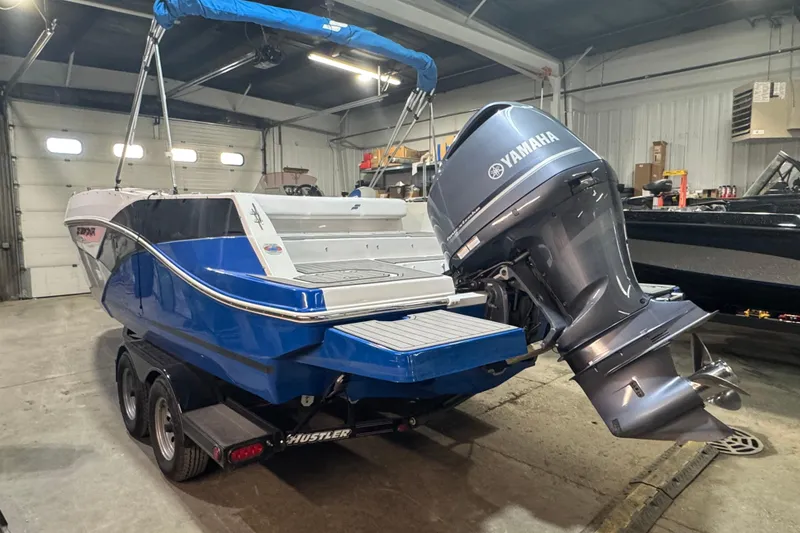 Slide: The Image of 2021 Starcraft SVX 231 OB boat with Yamaha outboard motor in a garage. - 5