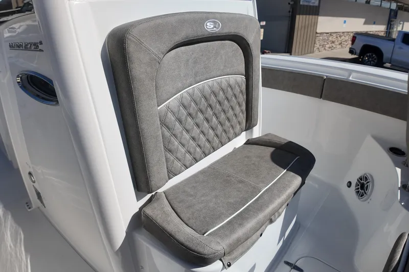 Slide: The Image of 2025 Sea Hunt Ultra 275 SE boat seat with gray upholstery and diamond stitching. - 12