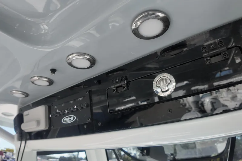 Slide: The Image of 2025 Sea Hunt Ultra 275 SE boat interior with control panel and lighting. - 14