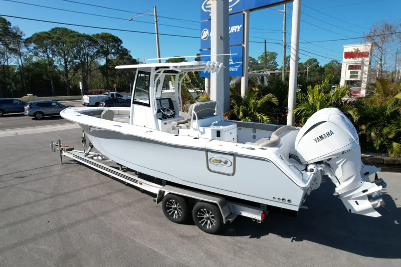 Slide: The Image of 2025 Sea Hunt Ultra 275 SE boat on trailer, featuring Yamaha engine, parked outdoors. - 22