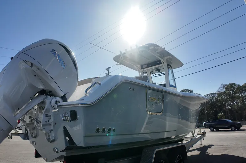 Slide: The Image of 2025 Sea Hunt Ultra 275 SE boat with Yamaha engine under bright sunlight. - 3
