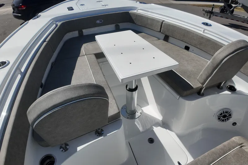 Slide: The Image of 2025 Sea Hunt Ultra 275 SE boat interior with seating and table setup. - 11