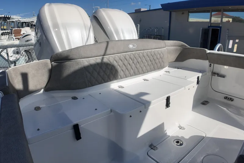 Slide: The Image of 2025 Sea Hunt Ultra 275 SE boat interior with cushioned seating and storage compartments. - 18