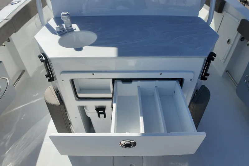 Slide: The Image of 2025 Sea Hunt Ultra 275 SE boat interior with open storage drawer and sink. - 21