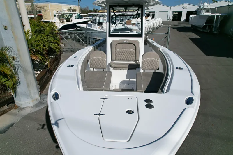 Slide: The Image of 2025 Sea Hunt Ultra 275 SE boat, sleek design, spacious seating, docked outdoors. - 5