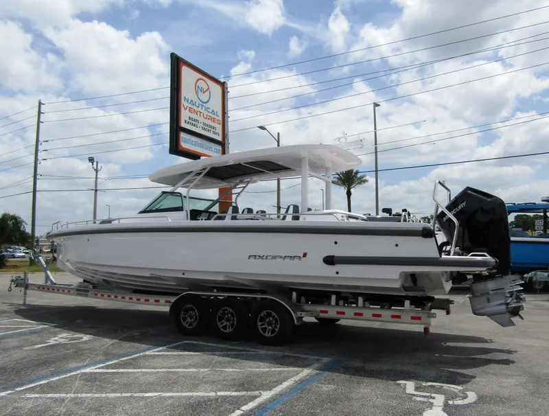 Slide: The Image of 2024 Axopar 37 Sun Top boat on trailer at Nautical Ventures dealership. - 1
