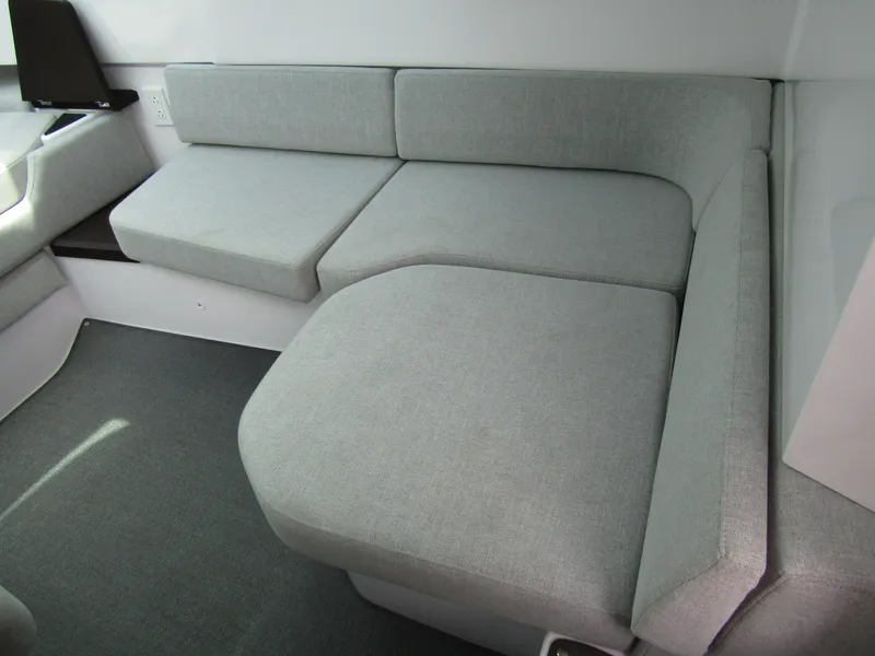 Slide: The Image of 2024 Axopar 37 Sun Top interior with gray cushioned seating area. - 22