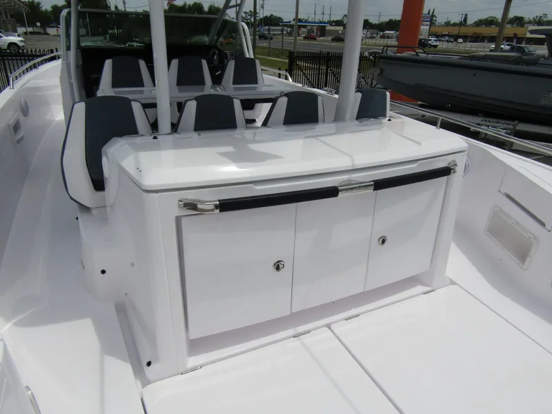 Slide: The Image of 2024 Axopar 37 Sun Top boat interior with sleek seating and storage area. - 30