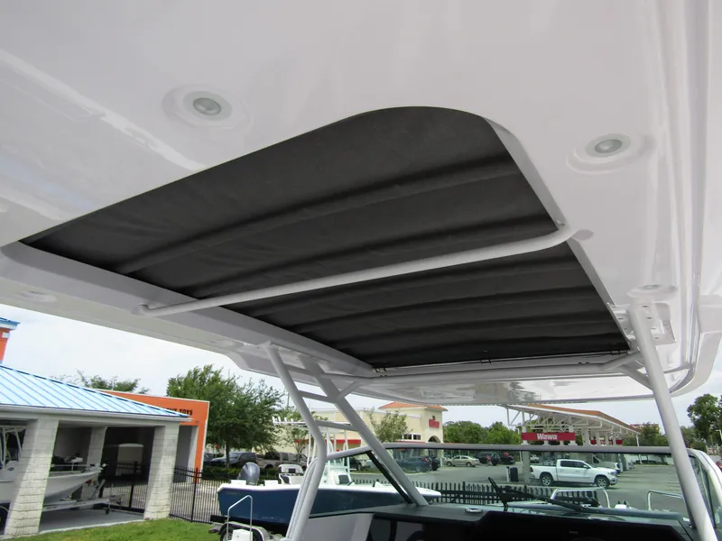 Slide: The Image of 2024 Axopar 37 Sun Top boat roof detail with retractable sunshade. - 35
