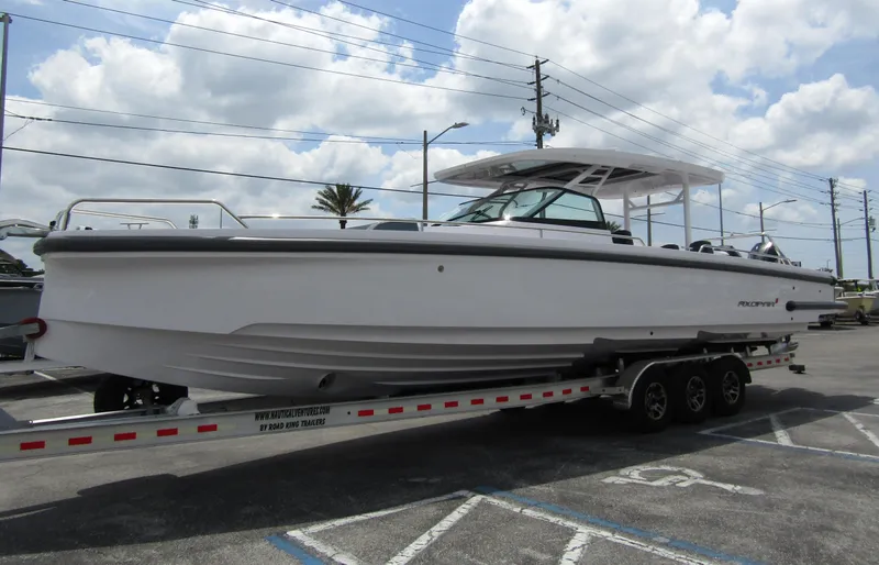 Slide: The Image of 2024 Axopar 37 Sun Top boat on trailer under cloudy sky. - 6