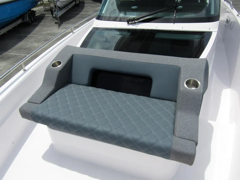 Slide: The Image of 2024 Axopar 37 Sun Top boat seating with cup holders and quilted design. - 12