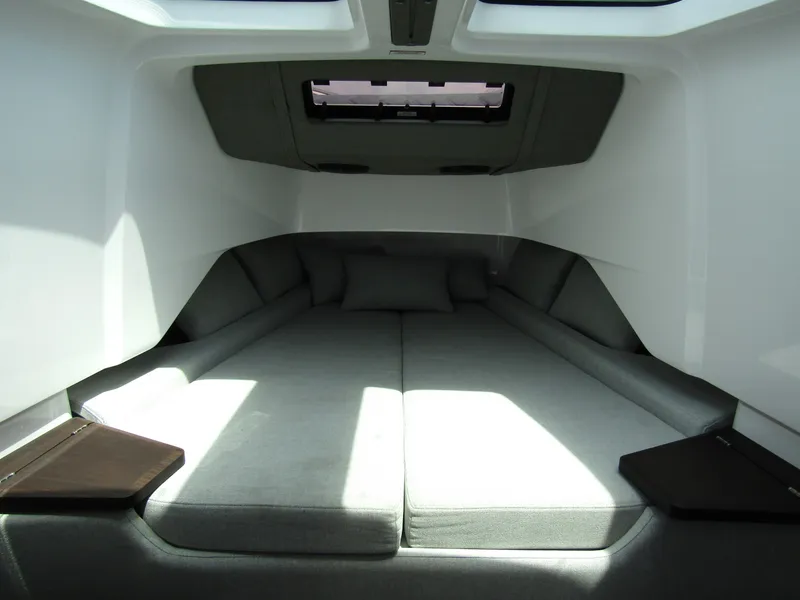 Slide: The Image of 2024 Axopar 37 Sun Top cabin interior with spacious bed and modern design. - 23