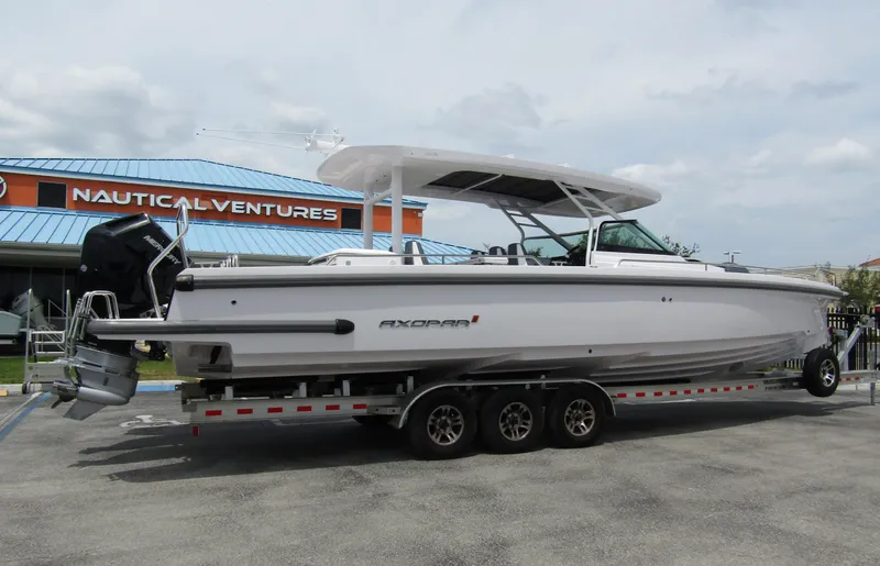 Slide: The Image of 2024 Axopar 37 Sun Top boat on trailer at Nautical Ventures dealership. - 3