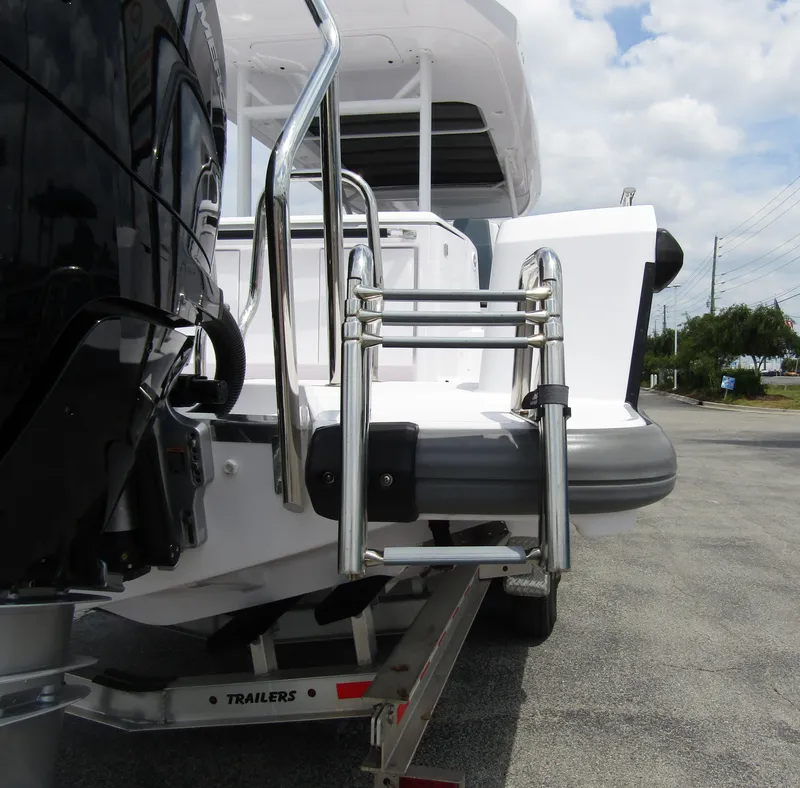 Slide: The Image of 2024 Axopar 37 Sun Top boat with stainless steel ladder and outboard motor. - 7