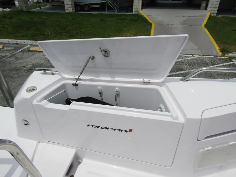 Slide: The Image of 2024 Axopar 37 Sun Top storage compartment open, showcasing spacious interior design. - 29