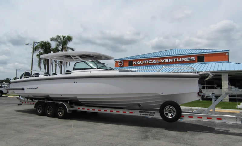 Slide: The Image of 2024 Axopar 37 Sun Top boat on trailer at Nautical Ventures dealership. - 5