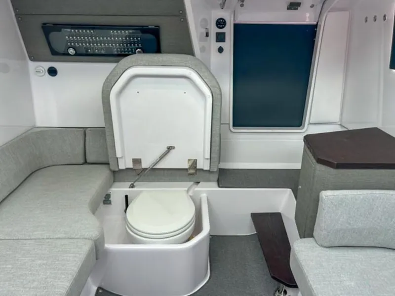 Slide: The Image of Interior of 2024 Axopar 37 Sun Top with seating and hidden toilet. - 16