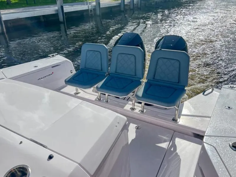 Slide: The Image of 2024 Axopar 37 Sun Top boat with three blue seats at the stern. - 21