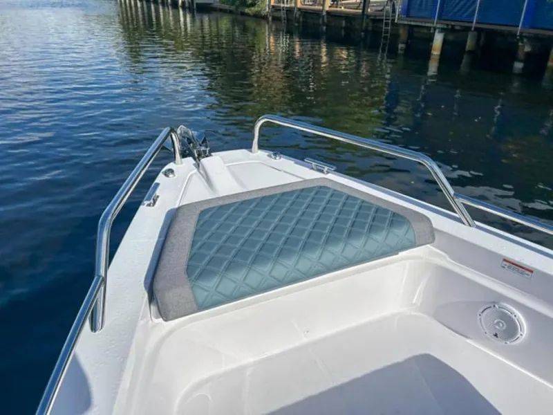 Slide: The Image of 2024 Axopar 37 Sun Top bow seating area on calm water. - 7