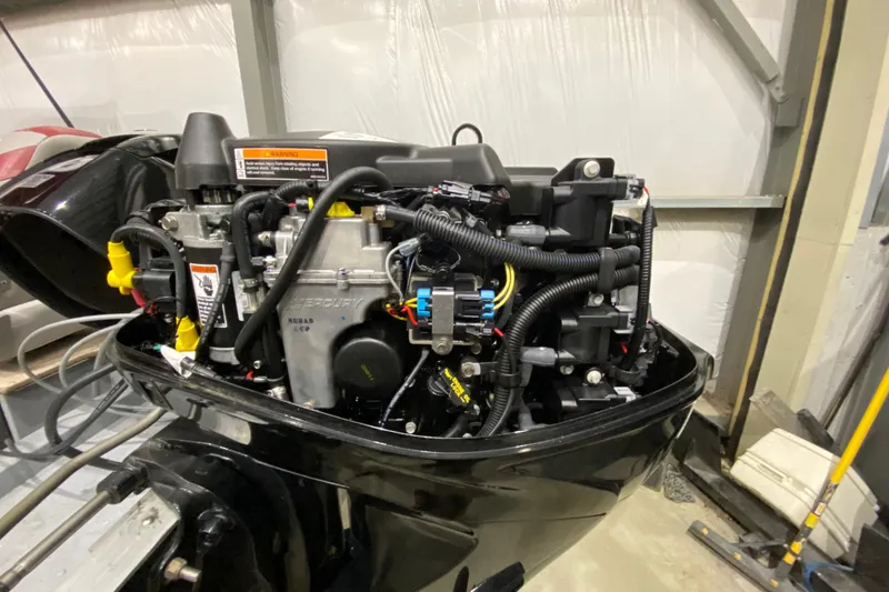 Slide: The Image of 2021 Lund SSV-18 boat engine close-up in a workshop setting. - 13