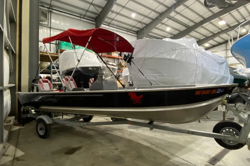 Slide: The Image of 2021 Lund SSV-18 boat with red canopy in indoor storage facility. - 3
